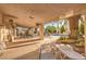 Covered outdoor patio seating area with views of the pool and surrounding landscape at 4471 Borrego Springs Way, Las Vegas, NV 89129