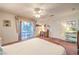 Bright bedroom with a ceiling fan, balcony access, and a cozy writing desk area at 4471 Borrego Springs Way, Las Vegas, NV 89129