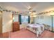 Bedroom with floral bedding, light walls and trim, and natural light at 4471 Borrego Springs Way, Las Vegas, NV 89129
