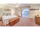 Well-lit bedroom featuring a comfortable bed and a sliding glass door to a balcony at 4471 Borrego Springs Way, Las Vegas, NV 89129