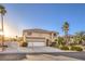 Elegant two-story home featuring a three-car garage, well-manicured landscaping, and mature palm trees at 4471 Borrego Springs Way, Las Vegas, NV 89129