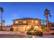 Elegant two-story home with a three-car garage, well-manicured landscaping, and a charming front porch with stone accents at 4471 Borrego Springs Way, Las Vegas, NV 89129