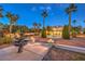 Professionally landscaped front yard with a fountain and mature palm trees creates a grand entrance at 4471 Borrego Springs Way, Las Vegas, NV 89129