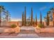 Front yard featuring professionally designed landscaping, a fountain, and manicured trees at 4471 Borrego Springs Way, Las Vegas, NV 89129