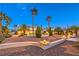 Beautifully landscaped front yard with a fountain, lighting, and mature palm trees create an inviting entrance at 4471 Borrego Springs Way, Las Vegas, NV 89129