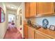 Hallway with natural wood cabinets, light walls and trim, and carpeting at 4471 Borrego Springs Way, Las Vegas, NV 89129