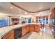 Large kitchen with white tile countertops, wood cabinets, and an adjacent dining area at 4471 Borrego Springs Way, Las Vegas, NV 89129