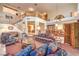 Open-concept living room boasts high ceilings, a staircase with wood railings, and ample natural light at 4471 Borrego Springs Way, Las Vegas, NV 89129