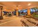 Charming covered patio with lounge chairs and seating area overlooking the sparkling pool and backyard at 4471 Borrego Springs Way, Las Vegas, NV 89129