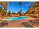 Beautiful backyard pool with lounge seating and mature landscaping offers a private retreat at 4471 Borrego Springs Way, Las Vegas, NV 89129