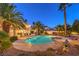 Gorgeous backyard pool with a spa, lush landscaping, and comfortable lounge seating for relaxation at 4471 Borrego Springs Way, Las Vegas, NV 89129