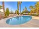 Refreshing pool with lush landscaping creates a serene backyard oasis for relaxation and enjoyment at 4471 Borrego Springs Way, Las Vegas, NV 89129