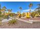 Beautifully landscaped front yard with fountain features and mature trees create a serene entrance at 4471 Borrego Springs Way, Las Vegas, NV 89129