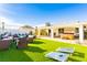 Spacious backyard with artificial turf, seating areas, and outdoor entertaining area with hot tub at 4471 Wisconsin Ave, Las Vegas, NV 89104