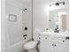 White bathroom featuring white vanity, and a tiled tub-shower, complete with modern fixtures at 4471 Wisconsin Ave, Las Vegas, NV 89104