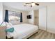 Comfortable bedroom featuring a bed, wood-look floors, TV, and a sliding door closet at 4471 Wisconsin Ave, Las Vegas, NV 89104