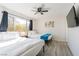 Bright bedroom featuring two twin beds, modern ceiling fan, and large windows for natural light at 4471 Wisconsin Ave, Las Vegas, NV 89104