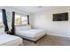Well-lit bedroom featuring dual beds, neutral carpeting, and a large window at 4471 Wisconsin Ave, Las Vegas, NV 89104