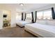 Spacious bedroom featuring two beds, soft carpet, and ensuite bathroom for added convenience at 4471 Wisconsin Ave, Las Vegas, NV 89104