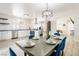 Bright dining area featuring modern light fixture and a view of the updated kitchen with stainless steel appliances at 4471 Wisconsin Ave, Las Vegas, NV 89104