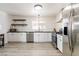 Updated kitchen with stainless steel appliances, subway tile backsplash, and plenty of cabinet storage at 4471 Wisconsin Ave, Las Vegas, NV 89104
