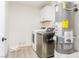 Convenient laundry area with a washer, dryer, and utility sink, providing functionality and efficiency at 4471 Wisconsin Ave, Las Vegas, NV 89104