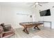 Spacious living room featuring modern flooring, billiard table, ceiling fan and stylish decor at 4471 Wisconsin Ave, Las Vegas, NV 89104