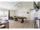 Bright living room with wood laminate flooring, entertainment area, pool table and a slider to the backyard at 4471 Wisconsin Ave, Las Vegas, NV 89104