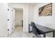 Bright office featuring wood-look floors with view to laundry area, offering a practical workspace at 4471 Wisconsin Ave, Las Vegas, NV 89104