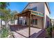View of backyard covered patio with brick area, landscaping, and access to the home's interior at 4846 Lone Grove Dr, Las Vegas, NV 89139