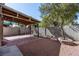 Backyard covered patio with brick and gravel area with privacy walls and landscaping at 4846 Lone Grove Dr, Las Vegas, NV 89139