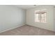 Well-lit bedroom with plush carpet, neutral walls, and a window offering natural light at 4846 Lone Grove Dr, Las Vegas, NV 89139