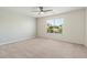Bright carpeted bedroom featuring a ceiling fan and a window providing natural light at 4846 Lone Grove Dr, Las Vegas, NV 89139