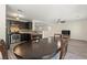 Bright dining area featuring luxury vinyl plank flooring, dark cabinets, stainless appliances, and stylish light fixtures at 4846 Lone Grove Dr, Las Vegas, NV 89139