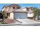 Two-story home featuring an attached two-car garage with a driveway and landscaped front yard at 4846 Lone Grove Dr, Las Vegas, NV 89139