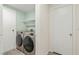 Efficient laundry room with modern washer/dryer units and functional shelving, maximizing space at 4846 Lone Grove Dr, Las Vegas, NV 89139