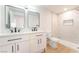 Bathroom featuring a dual sink vanity, modern fixtures, and a walk-in shower with marble-style tiling at 4848 Fuentes Cir, Las Vegas, NV 89121