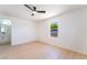 Neutral bedroom featuring light-colored floors, fresh paint and a window with leafy outdoor views at 4848 Fuentes Cir, Las Vegas, NV 89121