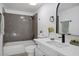 Stylishly updated bathroom with a shower-tub combo, quartz countertop, and modern black hardware at 4980 Indian River Dr # 447, Las Vegas, NV 89103