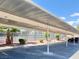 Shaded parking structure with tennis court in the background in a desert community under a blue sky at 4980 Indian River Dr # 447, Las Vegas, NV 89103