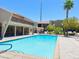 Inviting community pool with nearby lounge chairs, palm trees, and shade; perfect for relaxation and social gathering at 4980 Indian River Dr # 447, Las Vegas, NV 89103