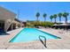 Community pool with a baja step, desert landscaping, shaded seating areas and a sundeck with lounge chairs at 4980 Indian River Dr # 447, Las Vegas, NV 89103