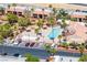 Aerial view of a sparkling community pool surrounded by lush landscaping and well-maintained apartment buildings at 4980 Indian River Dr # 447, Las Vegas, NV 89103