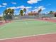 Active tennis courts with fresh red and green surfaces and community seating and shade structure at 4980 Indian River Dr # 447, Las Vegas, NV 89103