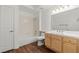Bright bathroom features a shower over tub, tile surround, and wood-look flooring at 5250 S Rainbow Blvd # 1029, Las Vegas, NV 89118