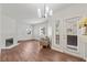 Bright living room with modern light fixture, fireplace, wood flooring, and access to the outside at 5250 S Rainbow Blvd # 1029, Las Vegas, NV 89118