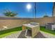 Backyard featuring a patio set, brick walls, artificial grass and sunny skies at 5269 Silver Branch Ave, Las Vegas, NV 89118