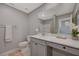 Bathroom with white cabinets, a white countertop, a large mirror and a visible shower at 5269 Silver Branch Ave, Las Vegas, NV 89118