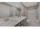 Bathroom features a double sink vanity, a shower and tub combination, and neutral walls at 5269 Silver Branch Ave, Las Vegas, NV 89118