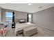 Bright primary bedroom with a large bed, carpet flooring, and natural light from two windows at 5269 Silver Branch Ave, Las Vegas, NV 89118